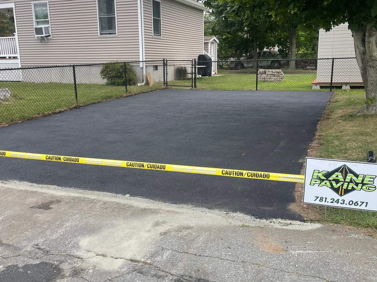 Finished asphalt driveway with stone curb